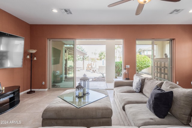 tiled living room featuring ceiling fan and plenty of natural light