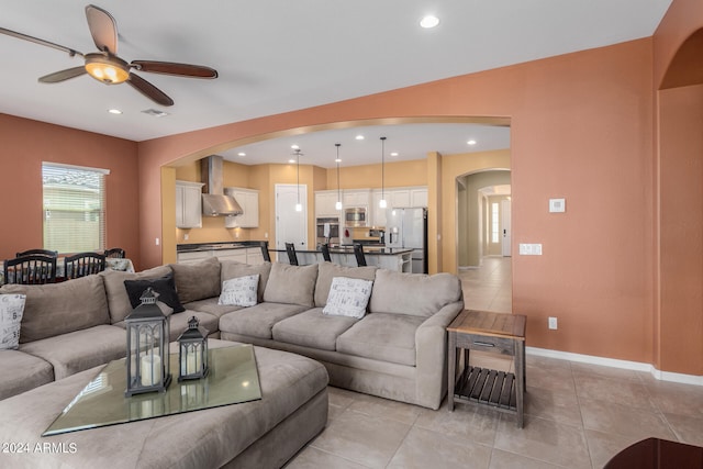 living room with ceiling fan and light tile patterned floors