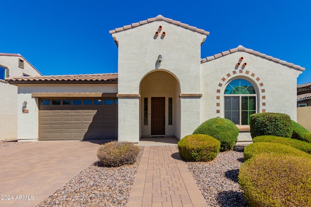 mediterranean / spanish-style home with a garage