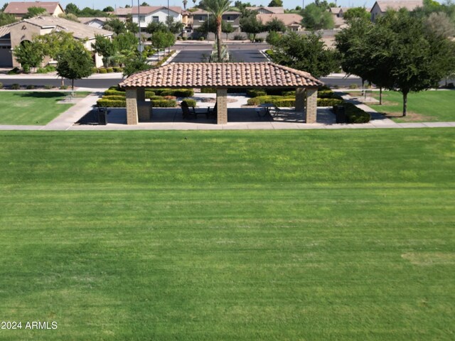 view of property's community with a lawn and a gazebo