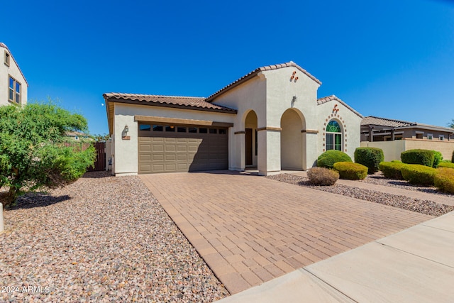 mediterranean / spanish-style house featuring a garage