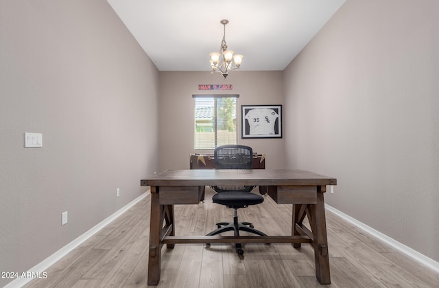 office space with light wood-type flooring and a notable chandelier