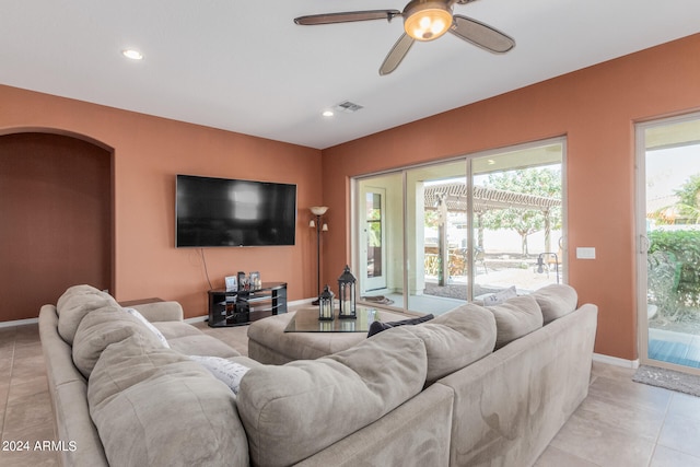 tiled living room with ceiling fan