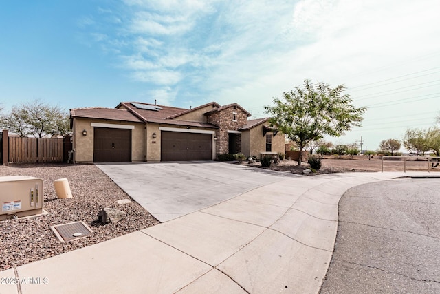 view of front of house featuring driveway, stucco siding, an attached garage, and roof mounted solar panels