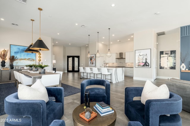 living room with sink and a high ceiling