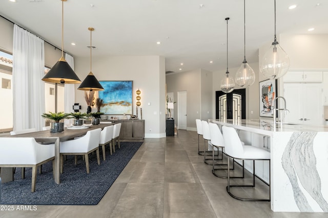 dining room with french doors, sink, and concrete floors