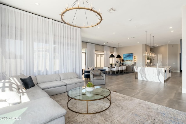 living room featuring a chandelier and sink