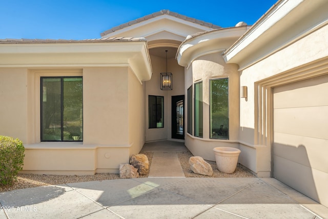 view of exterior entry with a patio area