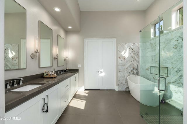 bathroom with tile patterned flooring, vanity, separate shower and tub, and tile walls