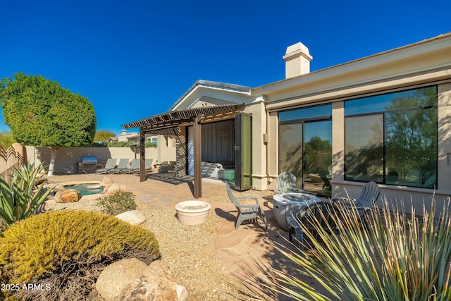 back of property featuring a pergola and a patio area