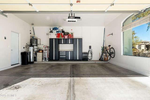 garage with a garage door opener and water heater