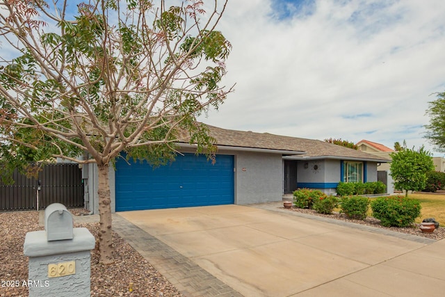 single story home featuring an attached garage, stucco siding, driveway, and fence