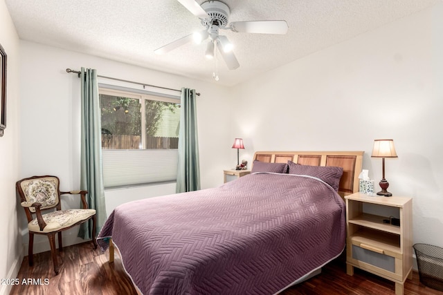 bedroom featuring baseboards, a ceiling fan, a textured ceiling, and wood finished floors