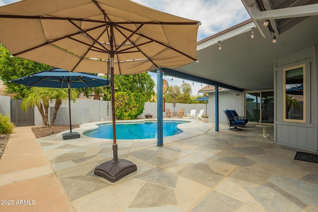 view of swimming pool with a fenced in pool, a fenced backyard, and a patio area