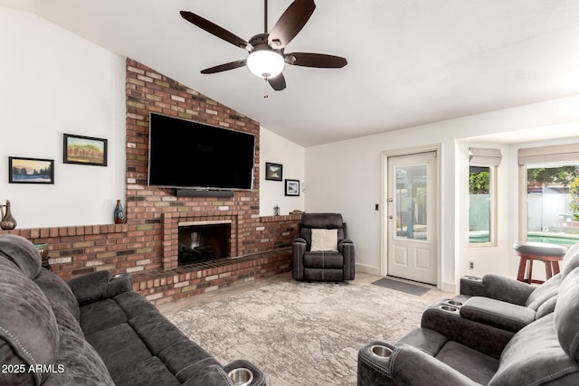 carpeted living room featuring ceiling fan, a fireplace, and vaulted ceiling