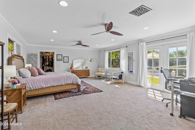 carpeted bedroom featuring a closet, ornamental molding, a spacious closet, ceiling fan, and french doors