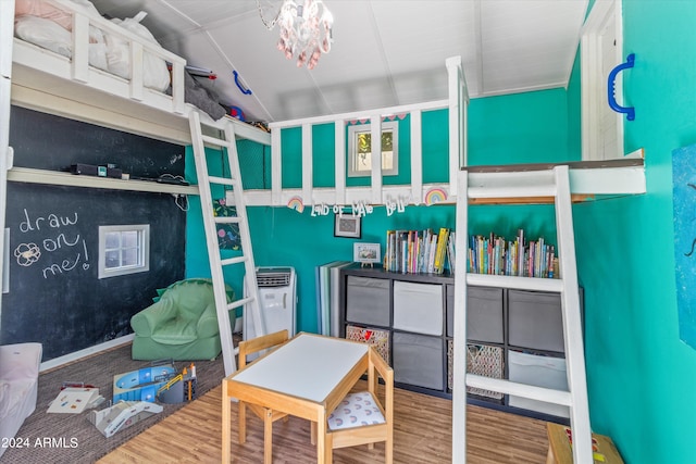 bedroom with lofted ceiling and hardwood / wood-style flooring