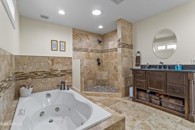 bathroom with tile walls, shower with separate bathtub, and vanity