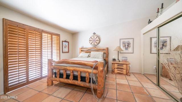 tiled bedroom featuring a closet