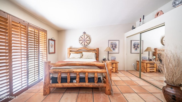 tiled bedroom with a closet