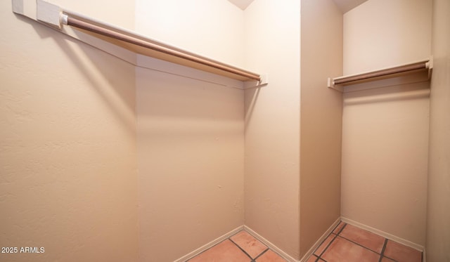 spacious closet featuring light tile patterned floors