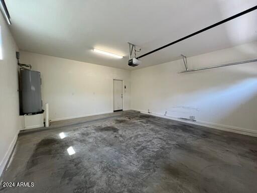 garage with a garage door opener and water heater