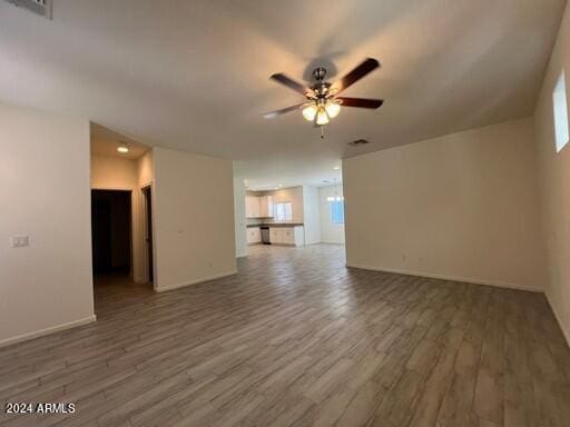 unfurnished living room with plenty of natural light, hardwood / wood-style flooring, and ceiling fan