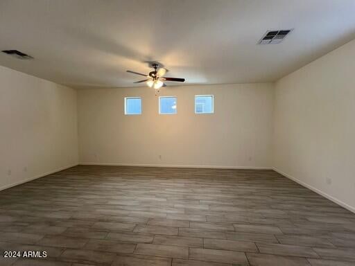 spare room featuring hardwood / wood-style flooring and ceiling fan