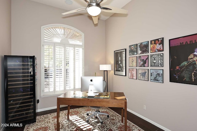 office space with ceiling fan, wood-type flooring, beverage cooler, and vaulted ceiling