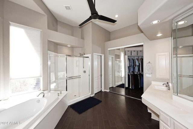 bathroom featuring vanity, ceiling fan, plus walk in shower, and hardwood / wood-style flooring