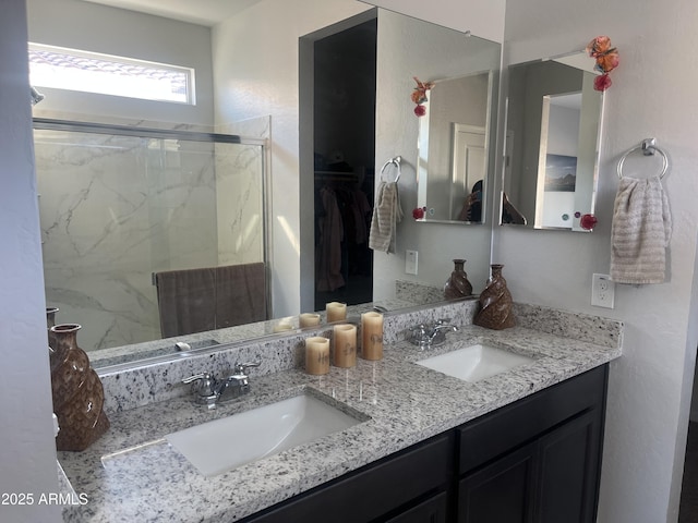 bathroom featuring vanity and a shower with door