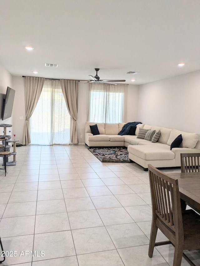 living room featuring ceiling fan and light tile patterned flooring