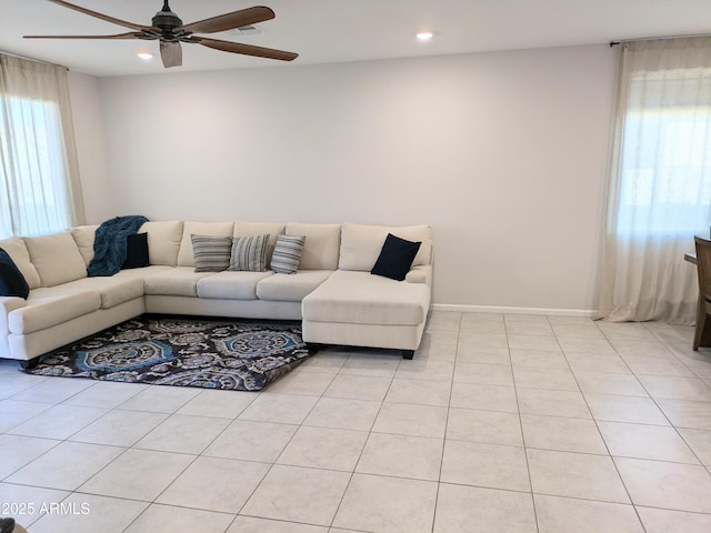 tiled living room with ceiling fan