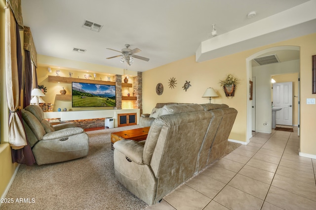 tiled living room featuring ceiling fan