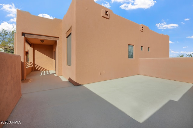 view of side of home with a patio area