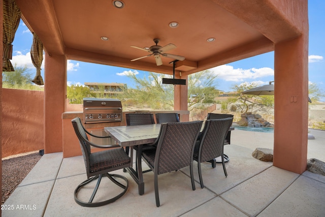 view of patio with ceiling fan, area for grilling, and a grill