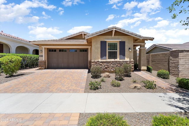 20684 W Meadowbrook Ave, Buckeye, AZ 85396 - ranch-style home featuring stucco siding, decorative driveway, a garage, a tiled roof, and stone siding