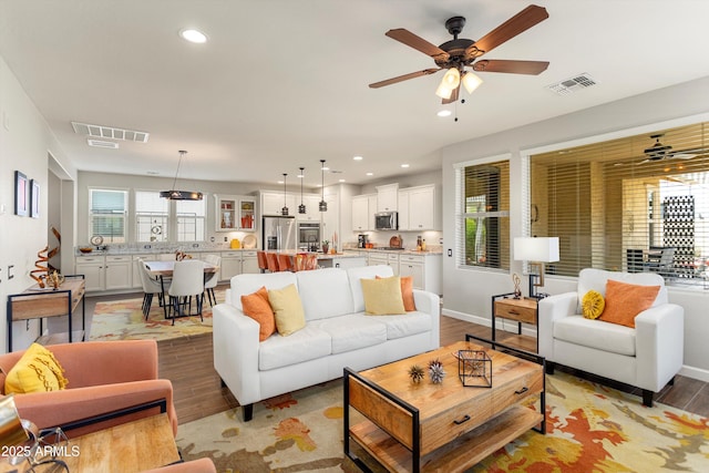 20684 W Meadowbrook Ave, Buckeye, AZ 85396 - living room with wood finished floors, a ceiling fan, and recessed lighting