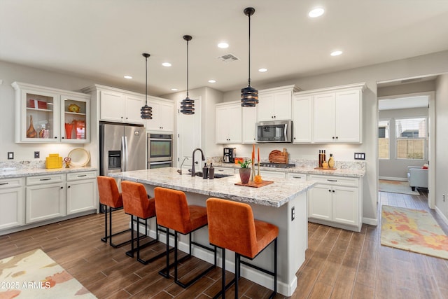 20684 W Meadowbrook Ave, Buckeye, AZ 85396 - kitchen with appliances with stainless steel finishes, dark wood-style floors, a breakfast bar, white cabinets, and recessed lighting