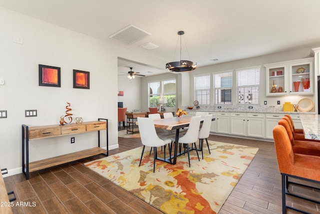 20684 W Meadowbrook Ave, Buckeye, AZ 85396 - dining room featuring dark wood-style floors, ceiling fan, and a chandelier