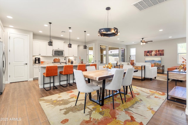 20684 W Meadowbrook Ave, Buckeye, AZ 85396 - dining room featuring recessed lighting, light wood-style floors, and ceiling fan