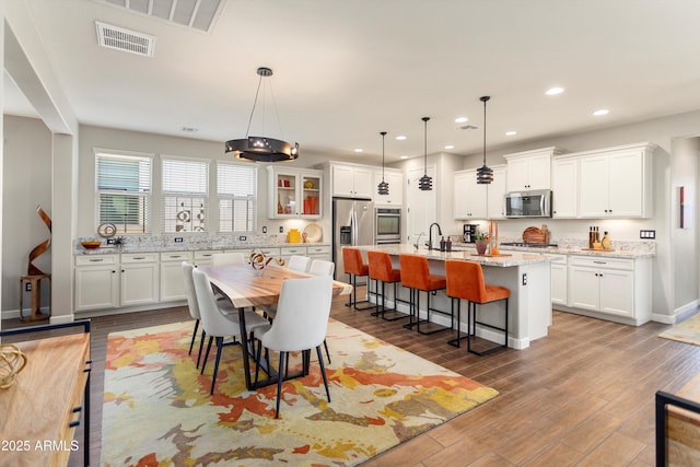 20684 W Meadowbrook Ave, Buckeye, AZ 85396 - dining area with wood finished floors and recessed lighting
