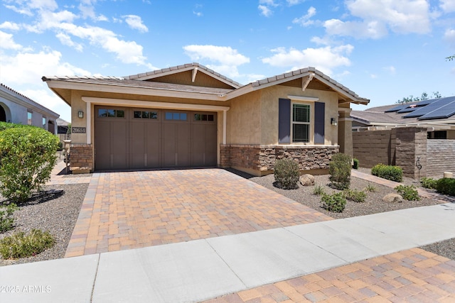 20684 W Meadowbrook Ave, Buckeye, AZ 85396 - single story home with stucco siding, stone siding, decorative driveway, and an attached garage