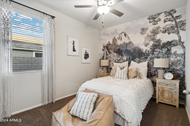 bedroom featuring ceiling fan and dark carpet