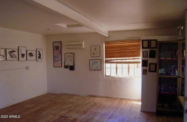 1837 W Roma Ave, Phoenix, AZ 85015 - interior space featuring a wall mounted AC, beam ceiling, and wood finished floors