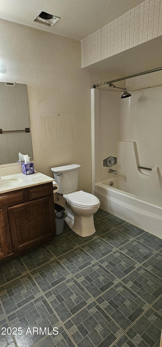 full bath featuring visible vents, toilet, shower / tub combination, a textured wall, and vanity