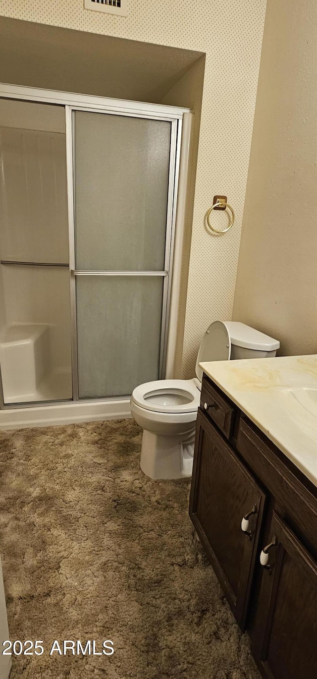 full bathroom with visible vents, a shower stall, toilet, and vanity