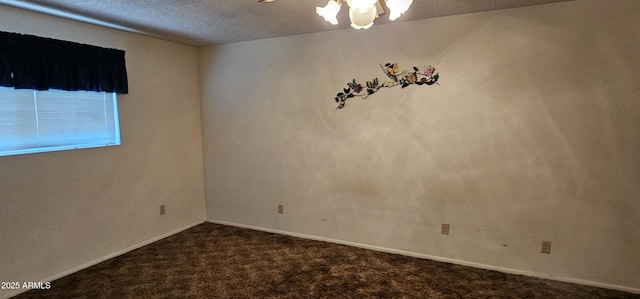 empty room with baseboards, carpet flooring, a textured ceiling, and ceiling fan