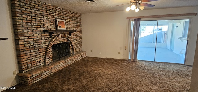 unfurnished living room with visible vents, a textured ceiling, carpet, a fireplace, and ceiling fan