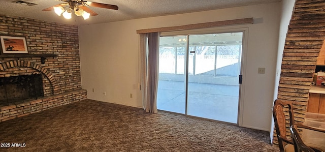 unfurnished living room with carpet flooring, a textured ceiling, and visible vents